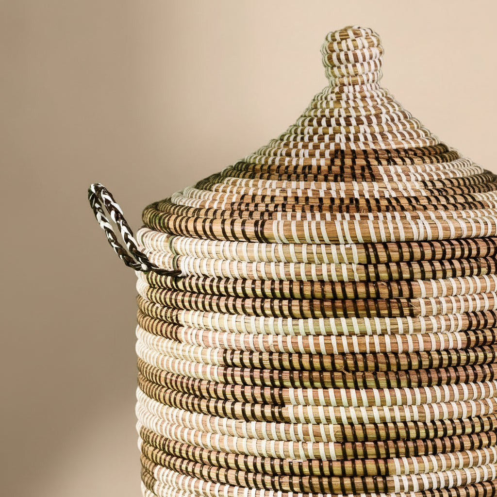 Woven basket with a lid on a green background
